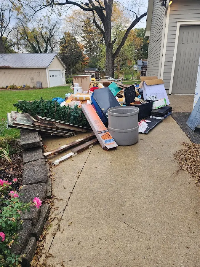 Dumpster being loaded with debris for 3 Yard Dumpster Rental in Stratham